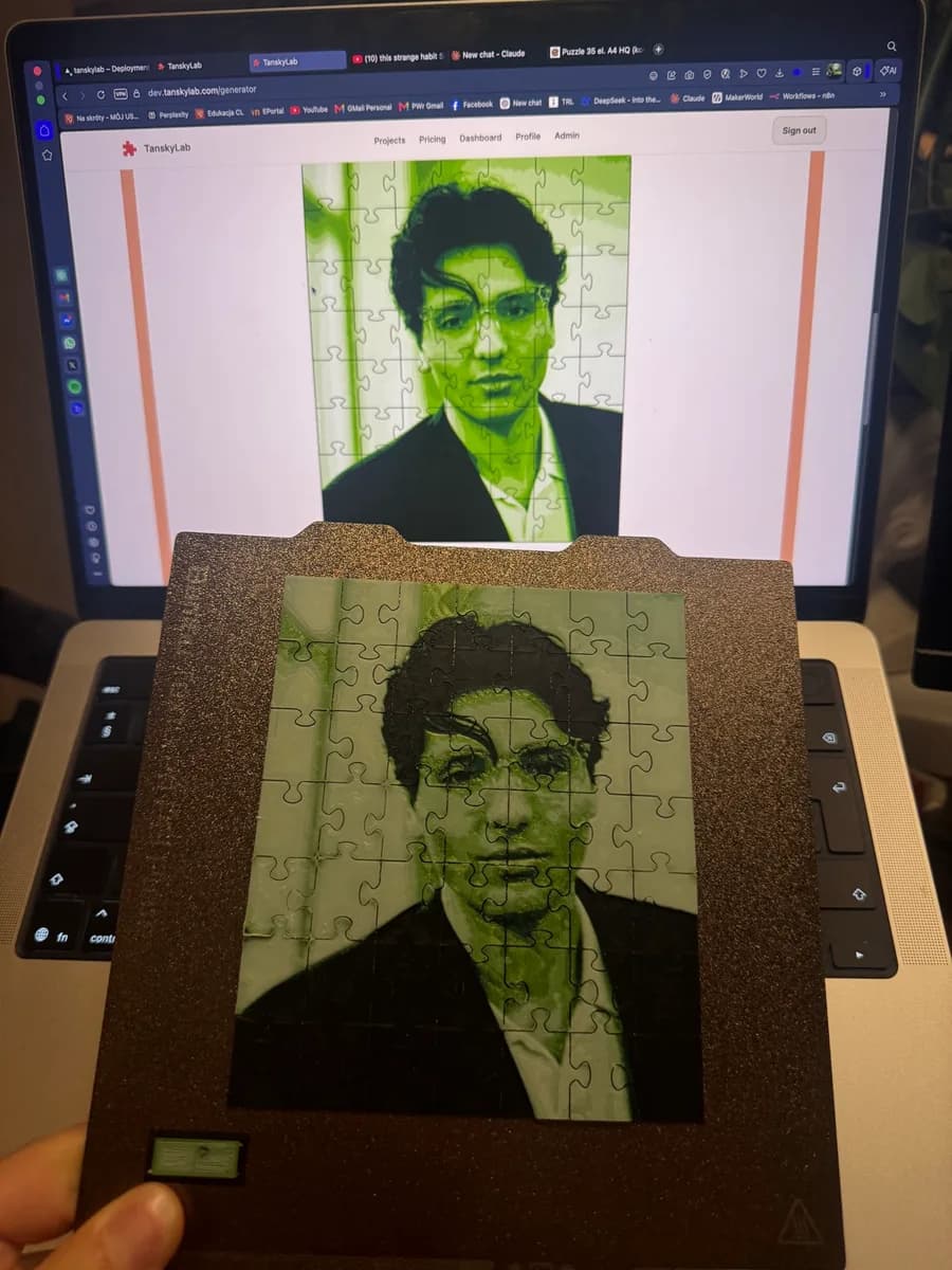 A portrait puzzle in the generator preview on a laptop screen, with the finished green and black printed puzzle held in front of it on the build plate