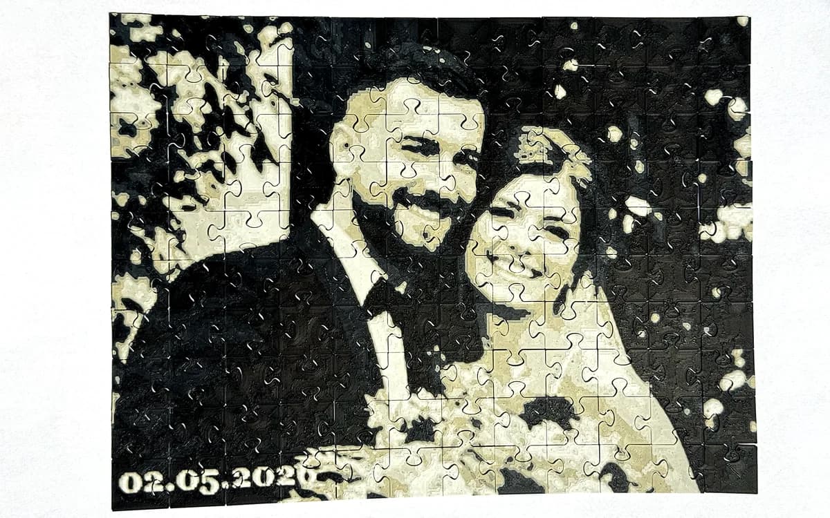 3D printed black and white photo puzzle of a wedding couple with the date 02.05.2026 in the corner